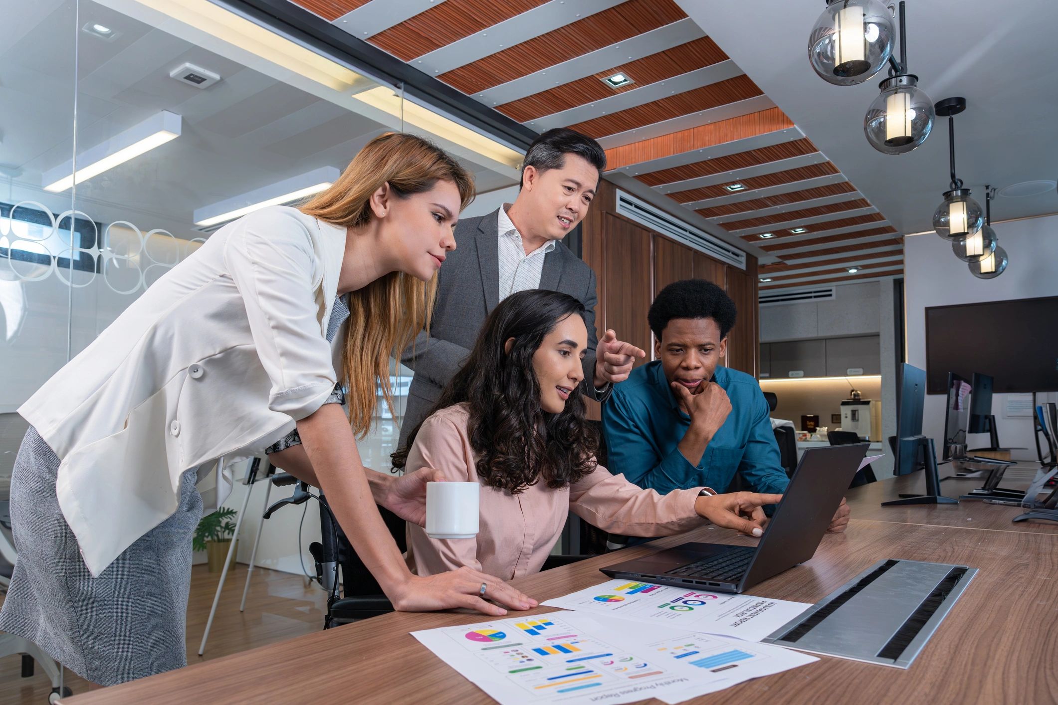 Professionals reviewing charts together in an office meeting room