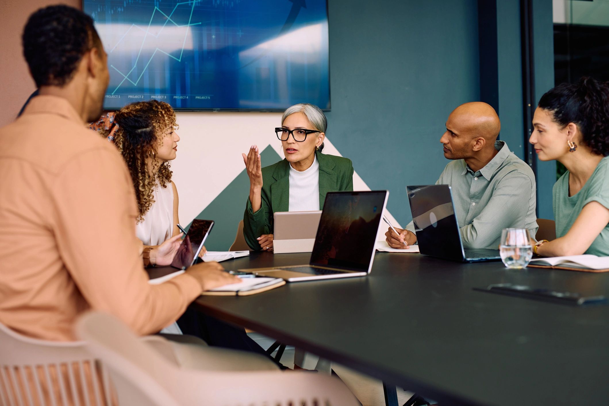 Diverse accounting team collaborating in a modern office meeting